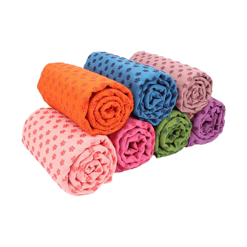 Brightly colored non slip yoga mat towels rolled up, perfect for fitness and Pilates.
