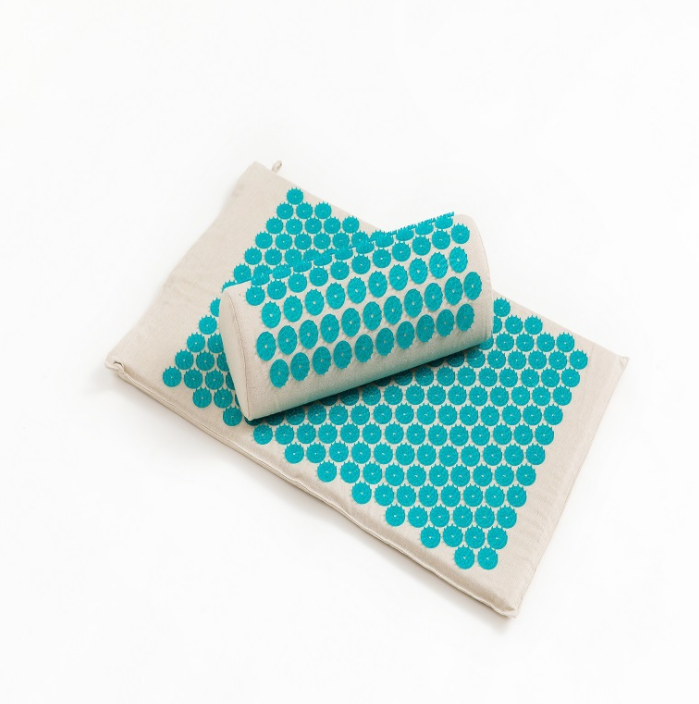 Acupressure mat for yoga with supportive pillow, designed to enhance relaxation and relieve tension.